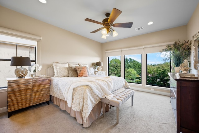 bedroom featuring light carpet and ceiling fan