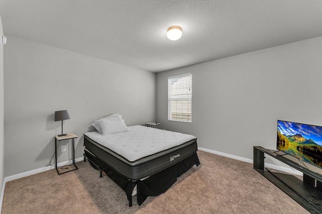 carpeted bedroom featuring a textured ceiling