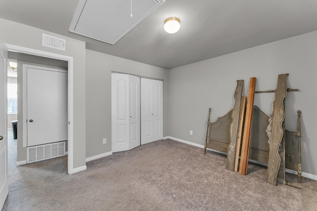 unfurnished bedroom with light colored carpet and a closet