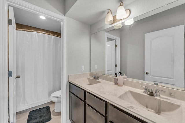 bathroom featuring tile patterned floors, vanity, and toilet