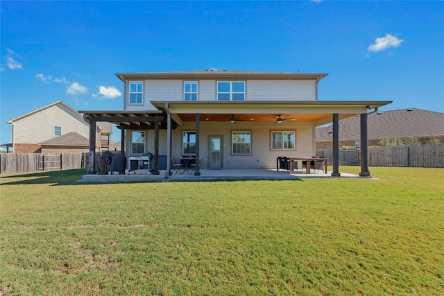 rear view of property featuring a patio, ceiling fan, and a lawn