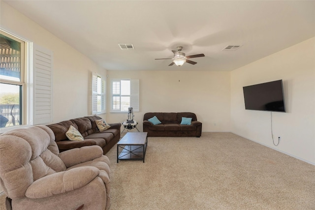 carpeted living room with ceiling fan