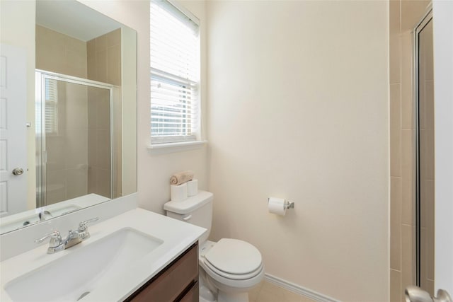 bathroom featuring vanity, toilet, and a shower with door