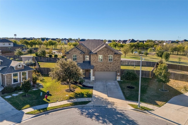 view of front of property with a garage and a front yard