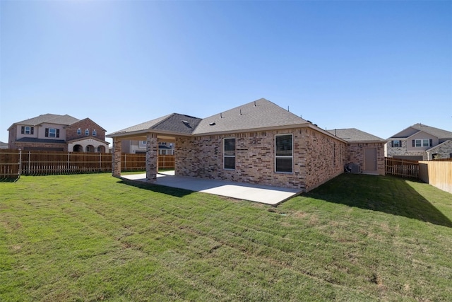 back of property featuring a patio and a lawn