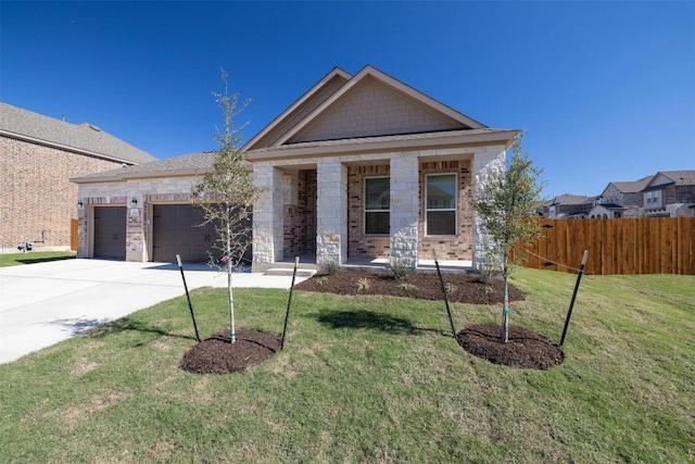 view of front of home with a front yard and a garage