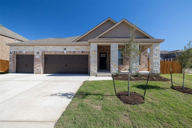 view of front of property featuring a front yard and a garage