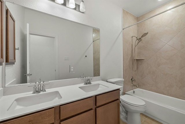 full bathroom featuring tile patterned floors, toilet, vanity, and tiled shower / bath