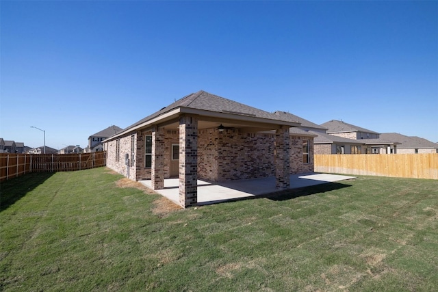 back of property featuring a lawn and a patio area