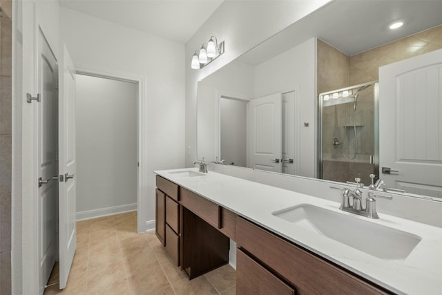 bathroom featuring tile patterned flooring, vanity, and a shower with shower door