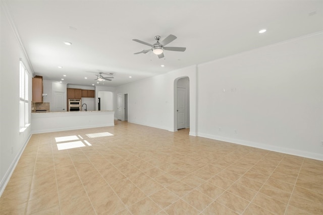 unfurnished living room featuring crown molding, ceiling fan, and light tile patterned flooring