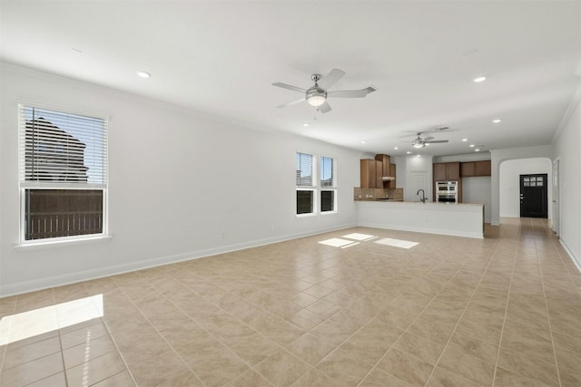 3601 Lapio Way, Round Rock, TX 78665 - unfurnished living room featuring recessed lighting, crown molding, a ceiling fan, light tile patterned floors, and a sink
