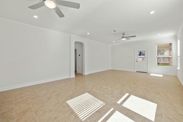 tiled empty room with ceiling fan and crown molding