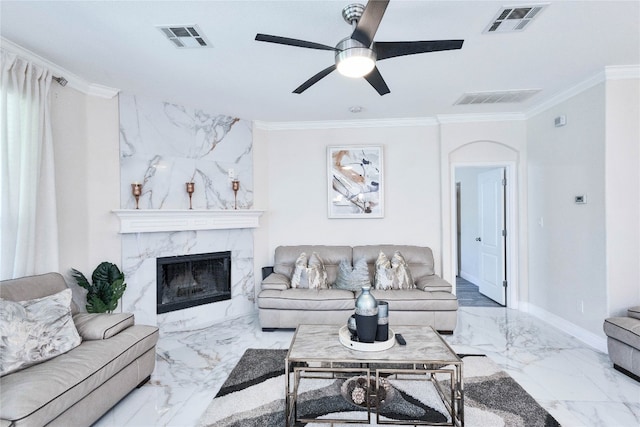 living room with ceiling fan, crown molding, and a fireplace