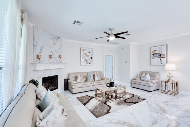 living room with ceiling fan, ornamental molding, and a high end fireplace