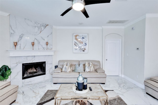 living room featuring a fireplace, ceiling fan, and ornamental molding