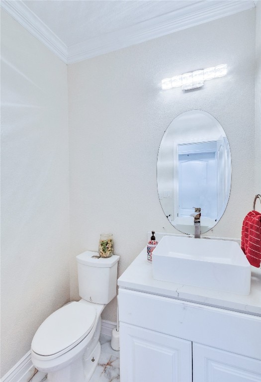 bathroom with crown molding, vanity, and toilet