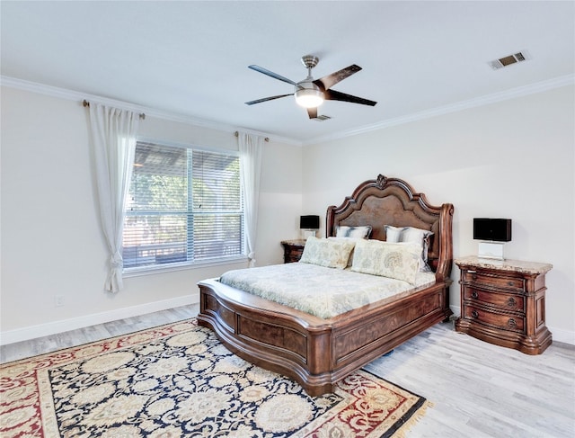 bedroom featuring light hardwood / wood-style flooring, ceiling fan, and crown molding