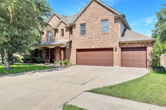 view of front facade with a front yard and a garage