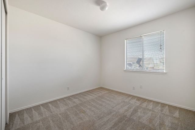 spare room with carpet floors and baseboards