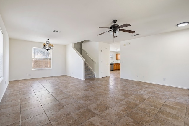 unfurnished living room featuring tile patterned floors and ceiling fan with notable chandelier