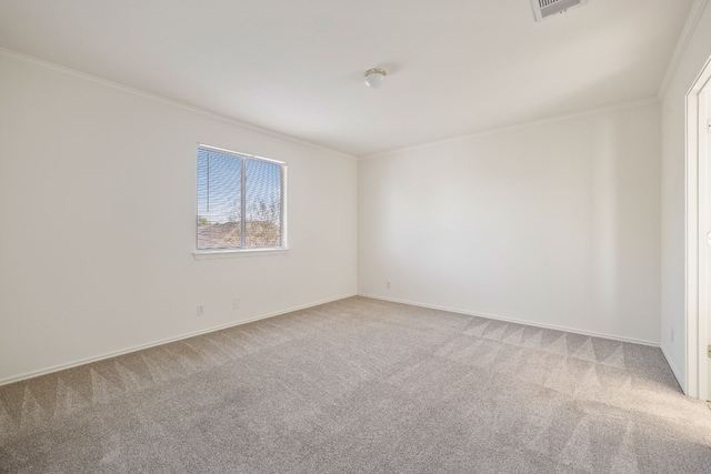 spare room featuring crown molding and light carpet