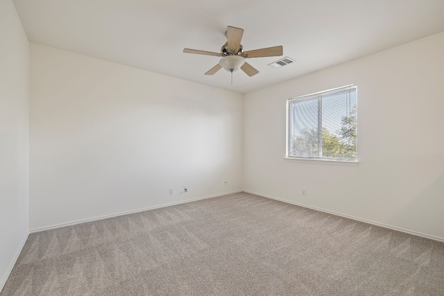 unfurnished room featuring light colored carpet and ceiling fan