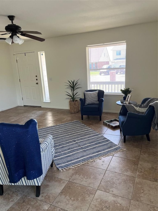 3104 Tyler Ln, Taylor, TX 76574 - tiled living room featuring a ceiling fan and baseboards