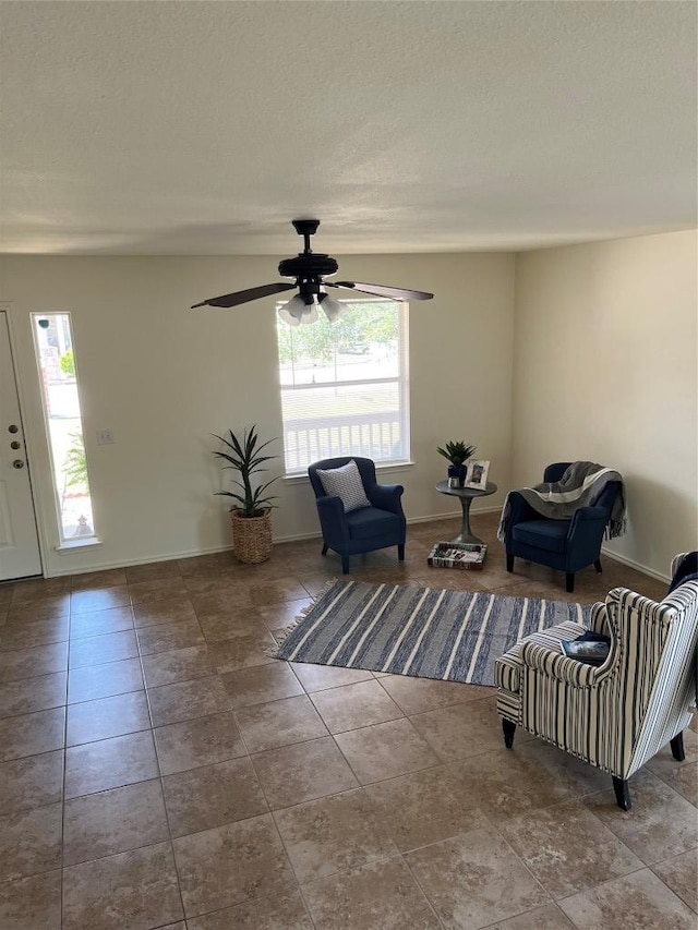 3104 Tyler Ln, Taylor, TX 76574 - sitting room featuring plenty of natural light, ceiling fan, baseboards, tile patterned floors, and a textured ceiling