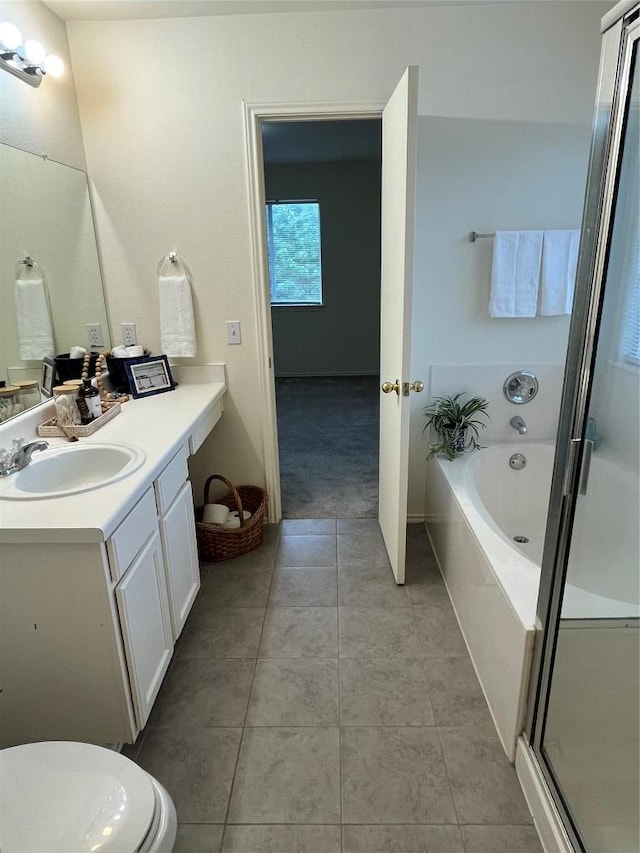 3104 Tyler Ln, Taylor, TX 76574 - full bath featuring vanity, a garden tub, toilet, tile patterned floors, and a stall shower
