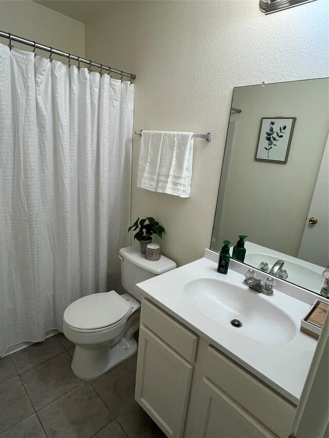 3104 Tyler Ln, Taylor, TX 76574 - bathroom with toilet, vanity, tile patterned floors, and a shower with shower curtain