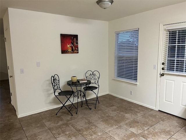 dining room with tile patterned flooring and baseboards