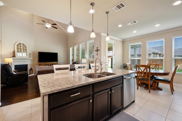 kitchen with ceiling fan, sink, dishwasher, a kitchen island with sink, and light tile patterned flooring