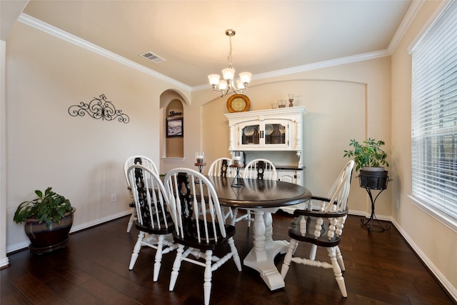 dining area featuring ornamental molding, dark hardwood / wood-style flooring, and a notable chandelier