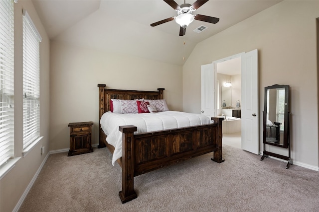 carpeted bedroom with ceiling fan, connected bathroom, and vaulted ceiling