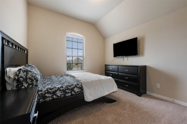 carpeted bedroom with lofted ceiling