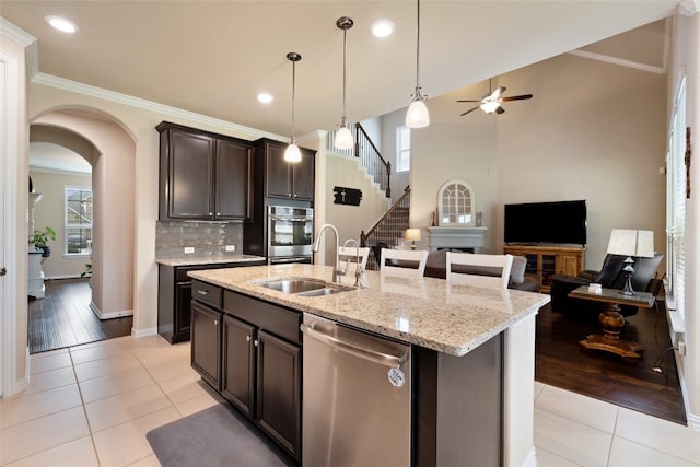 kitchen featuring dishwasher, plenty of natural light, sink, and a kitchen island with sink