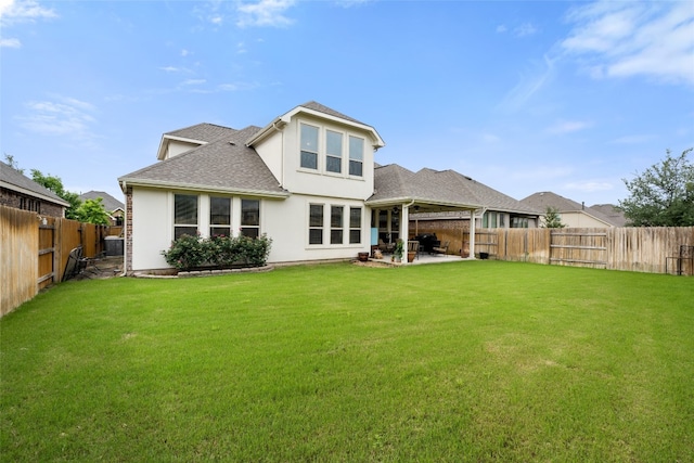 back of house with a lawn and a patio area