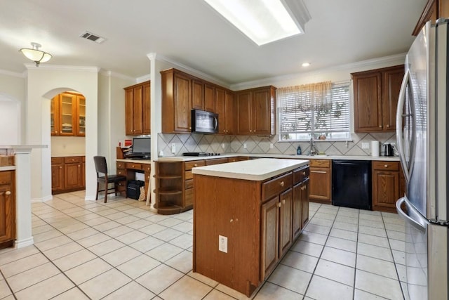 kitchen featuring tasteful backsplash, ornamental molding, a center island, and black appliances