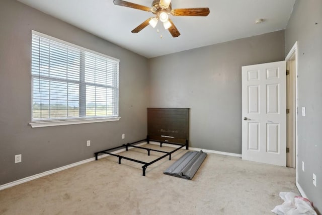 unfurnished bedroom featuring light colored carpet and ceiling fan