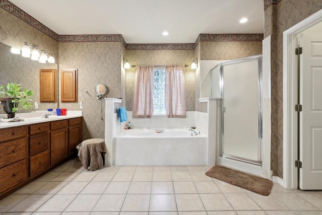 bathroom with tile patterned flooring, shower with separate bathtub, and vanity