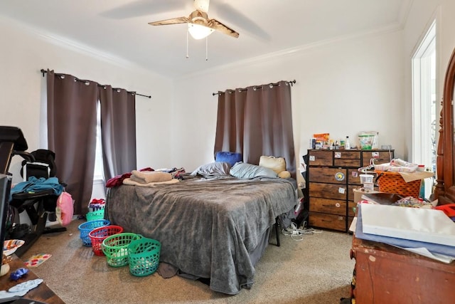 bedroom with ornamental molding, carpet flooring, and ceiling fan