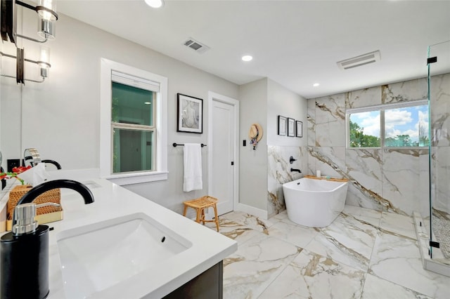 bathroom with marble finish floor, a marble finish shower, visible vents, and vanity