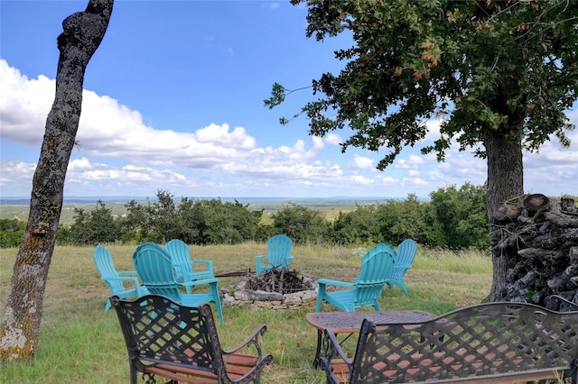 view of yard with an outdoor fire pit