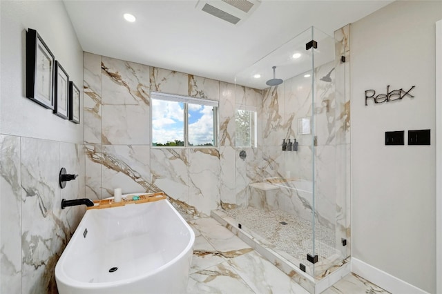 full bathroom with a freestanding tub, recessed lighting, visible vents, marble finish floor, and a marble finish shower