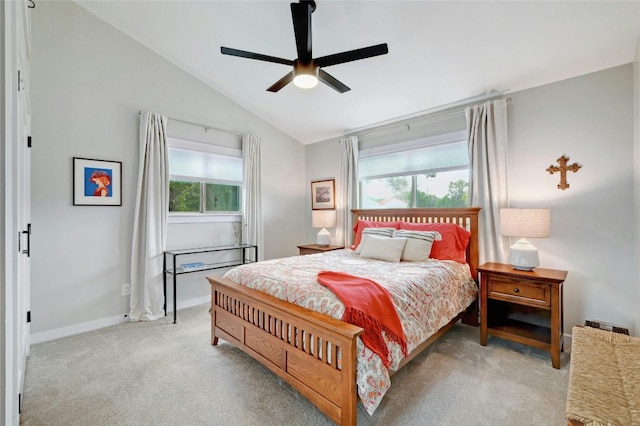 bedroom with vaulted ceiling, ceiling fan, baseboards, and light colored carpet