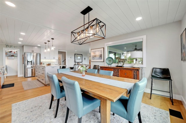 dining room featuring baseboards, light wood finished floors, wooden ceiling, and recessed lighting