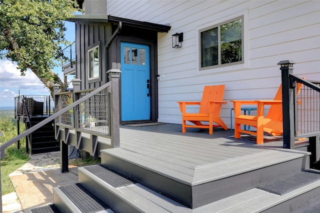 doorway to property featuring a deck and a chimney