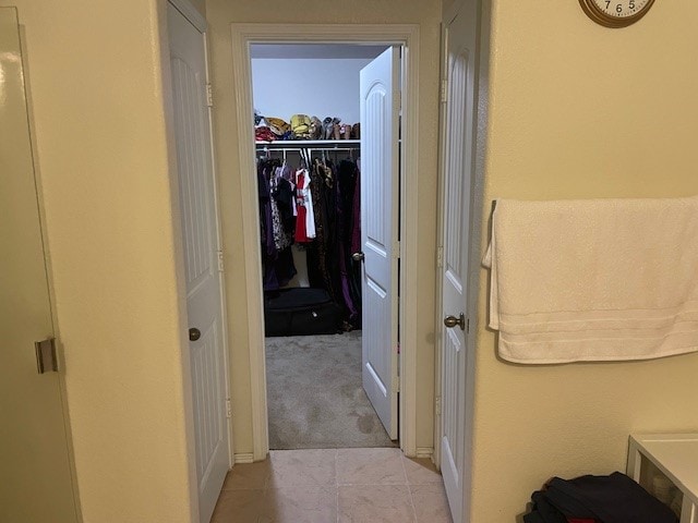 hallway with light colored carpet