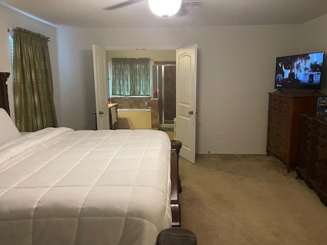 bedroom featuring ceiling fan, carpet, and ensuite bathroom